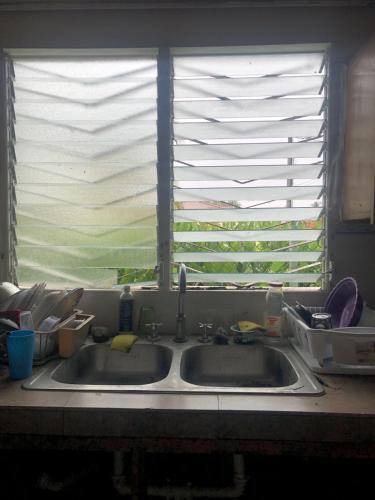 a kitchen sink in front of a window at The Green House in Bocas del Toro