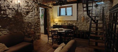 sala de estar con mesa y sillas y cocina en Le rondinelle, en Castelnuovo Parano