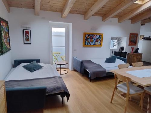 a room with two beds and a table at Boutique Apartments Cecilia in Trieste