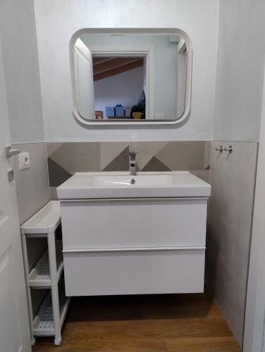 a bathroom with a white sink and a mirror at Boutique Apartments Cecilia in Trieste
