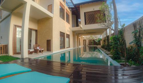a house with a swimming pool next to a building at Spicepeek Boutique Hotel CMB Airport in Katunayaka