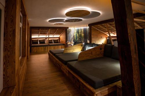 a room with a bed and a couch in it at Hotel Rio Bianco in Panchia