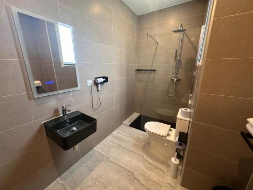 a bathroom with a sink and a toilet at La Bella Guesthouse in St Julian's