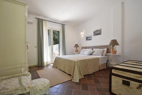 a bedroom with a bed and a door to a balcony at Masseria Pitanni in Gallipoli