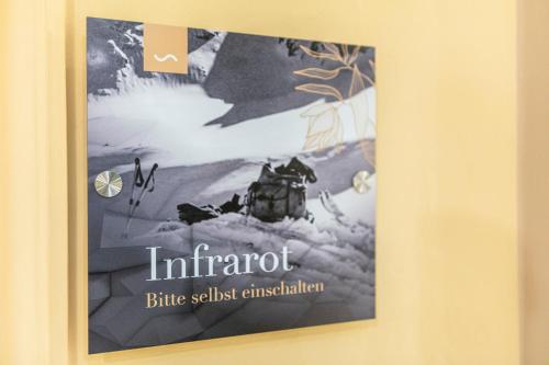 a poster hanging on a wall in a room at Hotel Oberwirt - nahe an Saalbach und Zell am See, Viehhofen Sommercard in Viehhofen