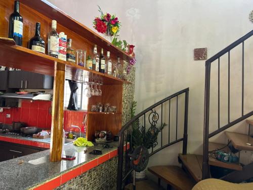 una cocina con una encimera con botellas en las estanterías en Casa para carnavales en Chitré, 