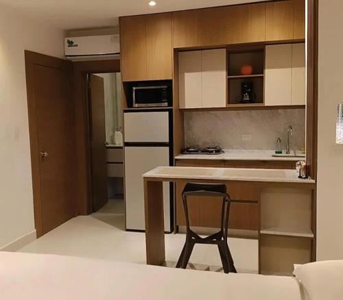 a kitchen with a table and a chair in a room at NOVAPARK HOTEL in Guayaquil