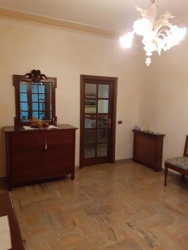 a living room with a dresser and a mirror at Gold House in Maranello