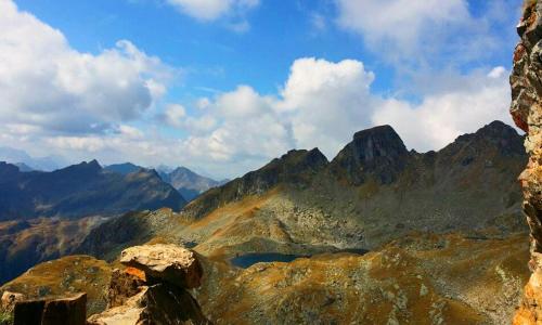 a view of a rocky mountain with a lake on it at Pension Gruber in Weisspriach
