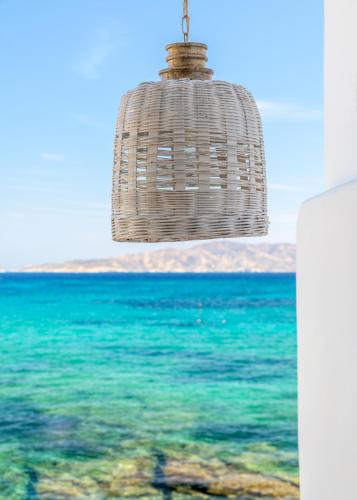 a rattan chandelier hanging over the ocean at villa lord in Pollonia