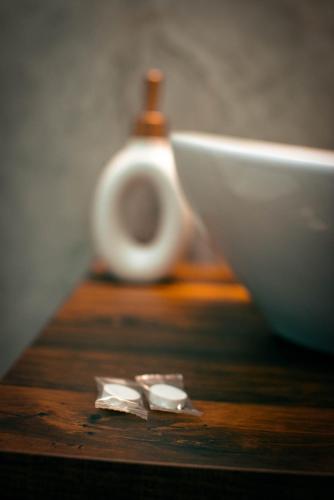 a wooden table with a white bowl and a white container at Widokowe Stodoły in Chyszówki