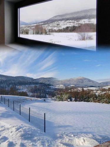 a window with a view of a snow covered field at Widokowe Stodoły in Chyszówki