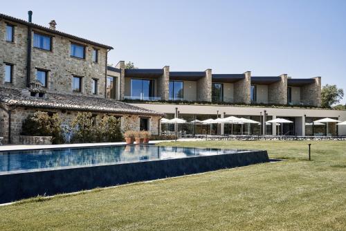an external view of a building with a swimming pool at Borgo Lanciano in Castelraimondo