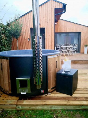 a hot tub sitting on top of a wooden deck at cottage du Fort Ambleteuse in Ambleteuse