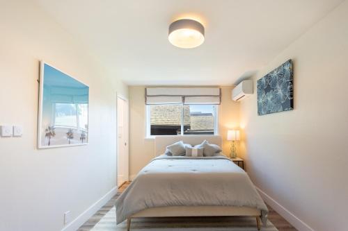 a white bedroom with a bed and a window at Downtown Mill Valley Modern Cozy Upstairs Apartment in Best San Francisco Bay Area in Mill Valley