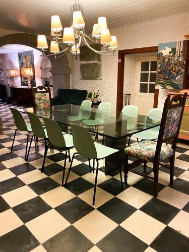 a dining room with a glass table and chairs at Solar Laginha - apartamentos e quartos in Afife