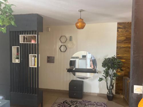 a living room with a mirror and a table at Douks in Dakar