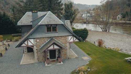an overhead view of a house on a river at L'Ecluse Simon in Tilff