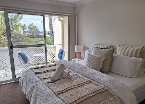a bedroom with a large bed with a large window at Isle of Palms 31 in Gold Coast