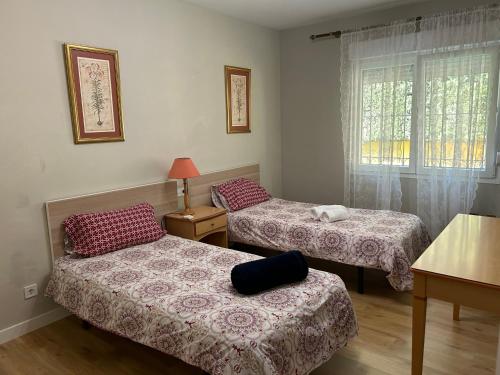 a room with two beds and a window at Villa Quimera en Marbella in Marbella