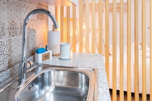a kitchen sink with a faucet on a counter at Loft Premium Córdoba in Córdoba