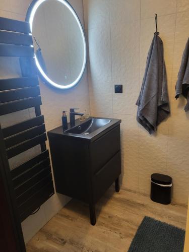 une salle de bain avec un lavabo noir et un miroir dans l'établissement Villa Sainte Marguerite, à Pornichet