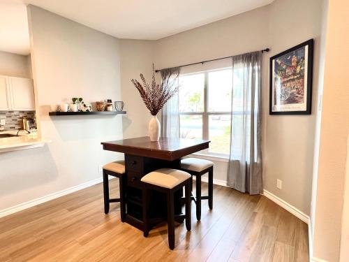a dining room with a table and chairs and a window at Modern 2 bedroom house w/backyard @La Cantera in San Antonio