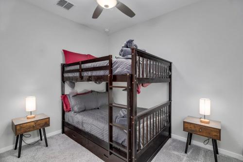 a bedroom with two bunk beds and two lamps at Heated Pool King Bed Pool Table Ping Pong in Litchfield Park