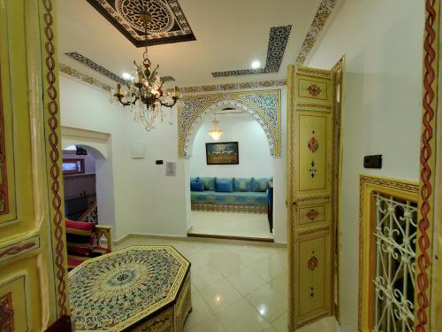 a living room with a couch and a chandelier at Blue city Chefchaouen in Chefchaouen