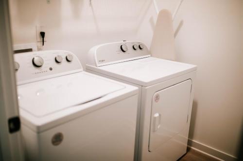two white appliances sitting next to each other in a kitchen at Artist Retreat - Near Downtown, Stadium, Campus in Athens