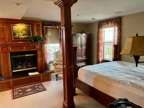 a bedroom with a bed and a fireplace at The Port Hotel in Port Washington