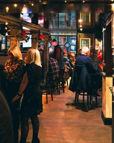 a group of people sitting in a bar at Mary Mullen's Rooms Eyre Square. in Galway