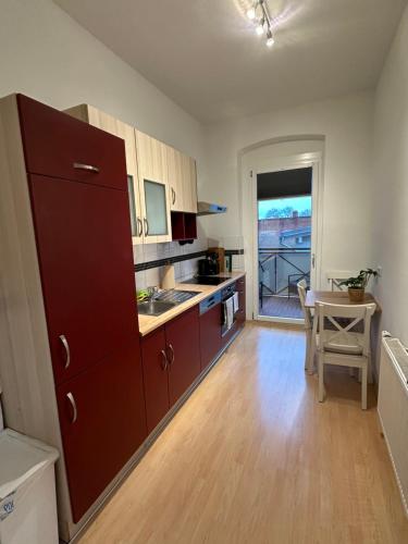 a kitchen with a large brown cabinet and a table at Ferienwohnung für 8 mit Balkon in Erfurt