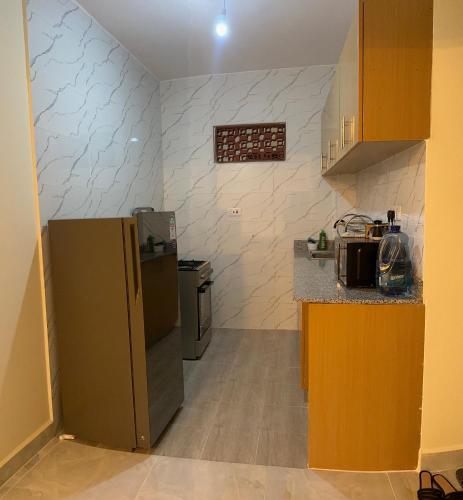 a kitchen with a refrigerator and a counter top at HOBAK STAYS in Nairobi