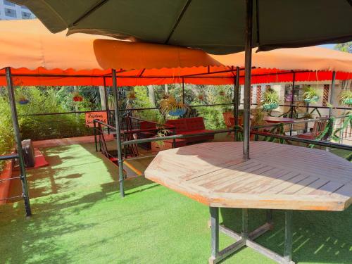 a picnic table under an umbrella on a patio at HOBAK STAYS in Nairobi
