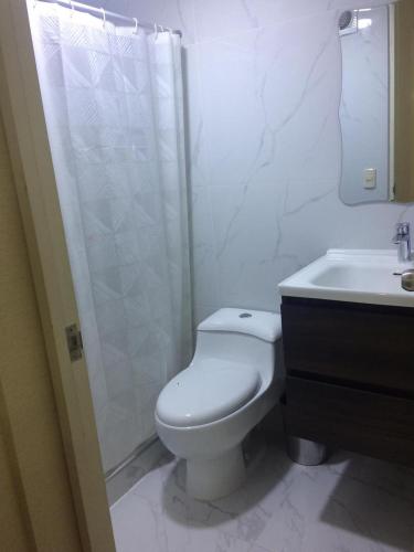 a bathroom with a toilet and a shower and a sink at Departamento VIP estreno en Condominio in Lima