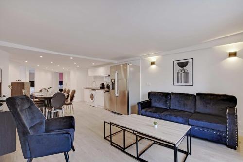 a living room with a couch and a table at CMG - Residence OpéraGrands Magasins in Paris
