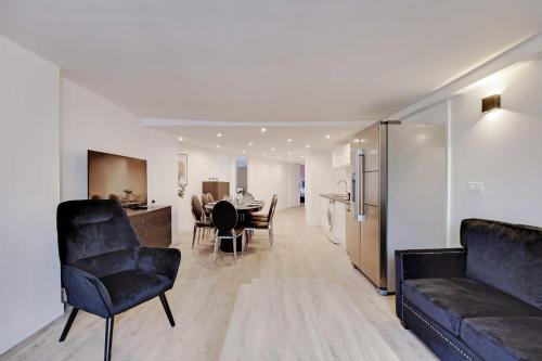 a living room with a couch and a table at CMG - Residence OpéraGrands Magasins in Paris