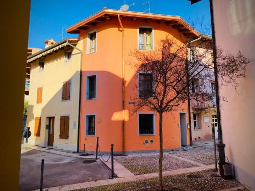 an orange and white building on a street at La Casetta in Piazzetta in Cormòns