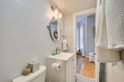 a white bathroom with a sink and a mirror at Cozy Somerville Studio 2 Mi to Boston, Walk to T! in Somerville