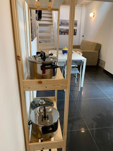 a kitchen with two pots and pans on a shelf at Villa GAUDÌ in Sant'Isidoro