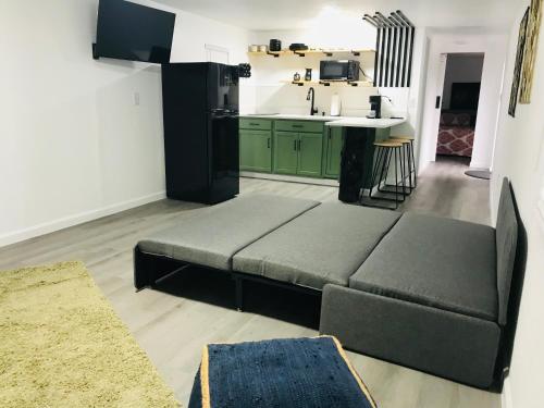 a living room with a couch in front of a kitchen at 10515 Houston Avenue in Hudson