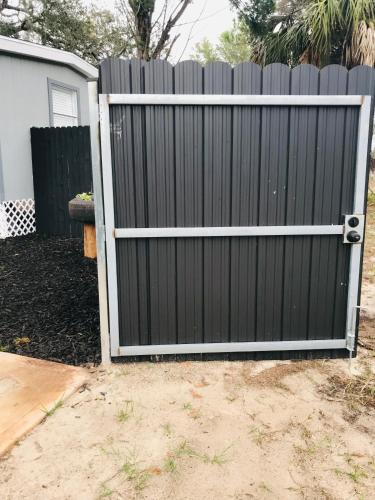 a black gate in front of a fence at 10515 Houston Avenue in Hudson