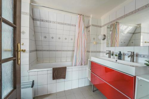 a bathroom with a tub and a sink at 2-Floor Traditional Prague Apartment in Prague