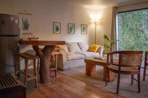 a living room with a couch and a table at Casa Camino Farellones in Santiago