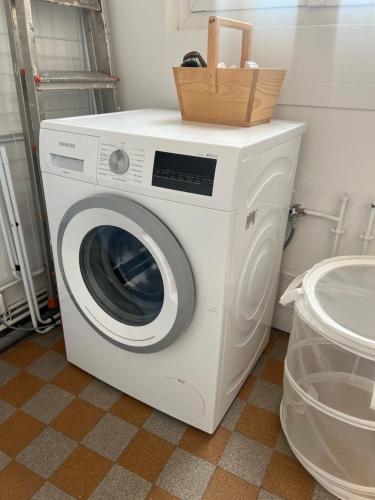 uma máquina de lavar roupa com um cesto em cima em Suite haussmannienne en Sologne em Vierzon
