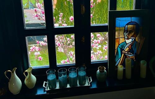 a window with a bunch of vases and a window with flowers at Blaje in Breaza de Jos