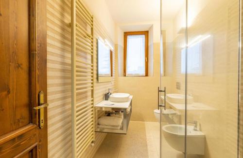 a bathroom with two sinks and a glass shower at Residenza San Donato in Montepulciano