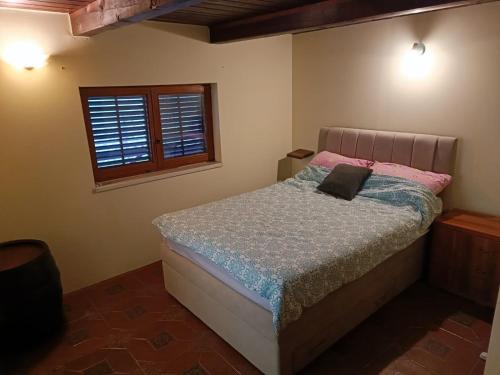 a bed in a bedroom with a window at Tessina kuća in Stubicke Toplice