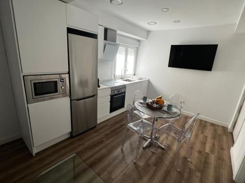 a kitchen with a table and chairs in a room at Apartamento Virgen del Mar in Almería